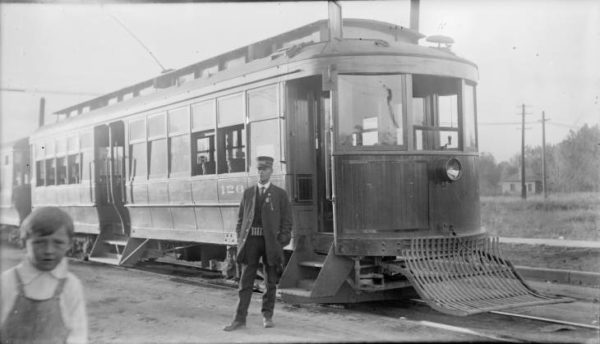 historic photo of Denver streetcar, its conductor, and a young boy