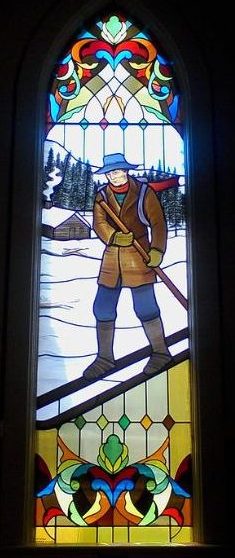 stained glass window portraying man on skis